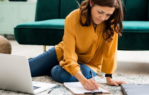 Women checks off a list of documents to refinance a mortgage