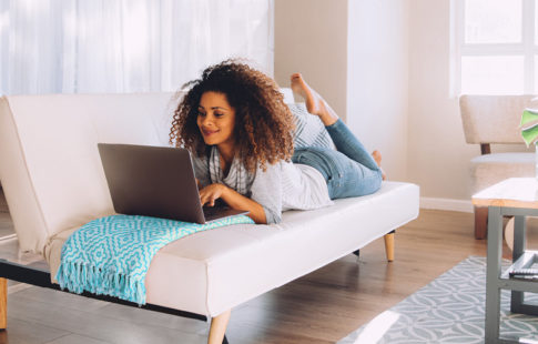 Woman Laying Down on Computer