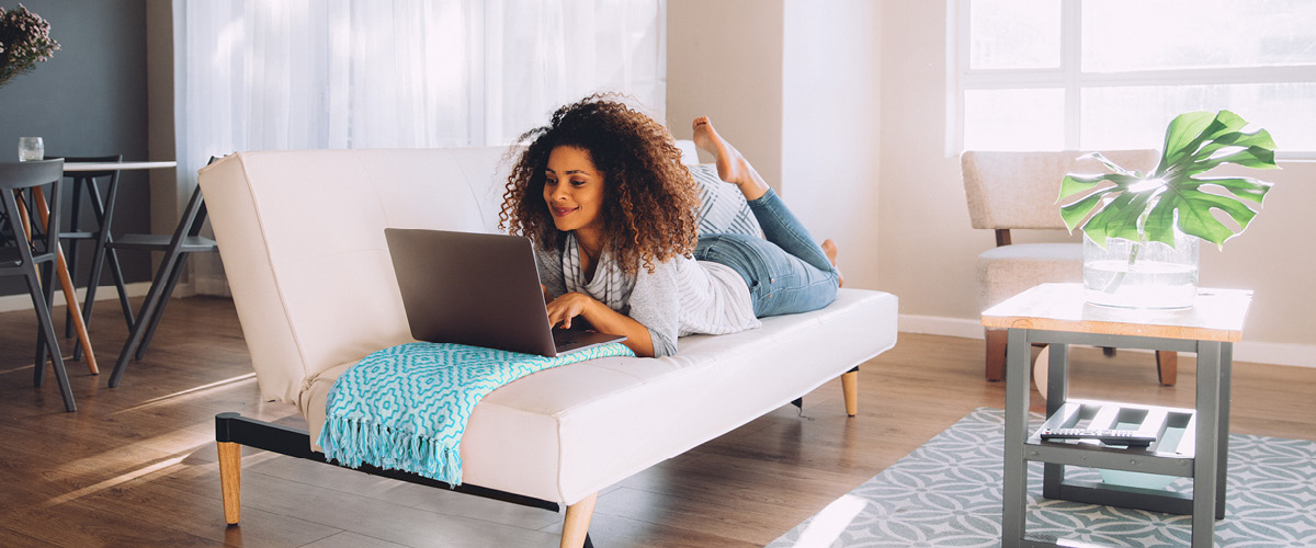 Woman Laying Down on Computer