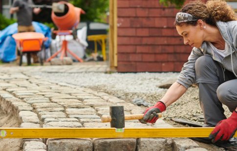 Women leveling paving stones, a possible DIY project idea from Instagram