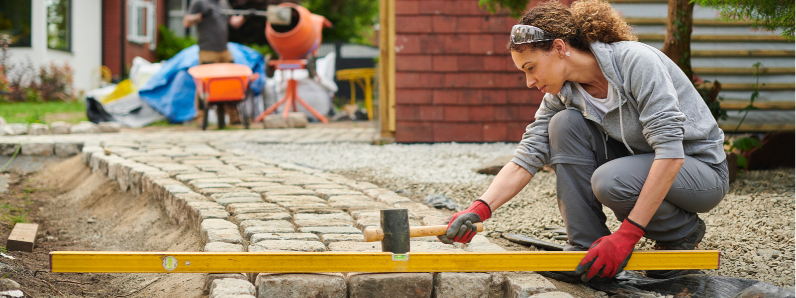 Women leveling paving stones, a possible DIY project idea from Instagram