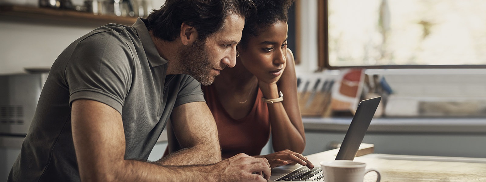 A couple looks at a laptop screen