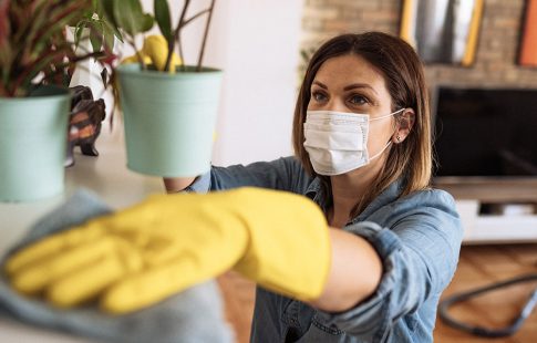 A woman cleans a shelf