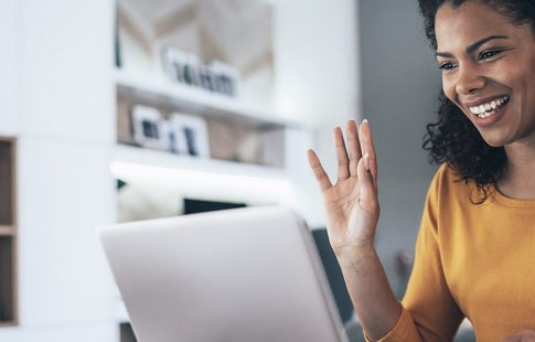 A woman joins a virtual meeting on her laptop