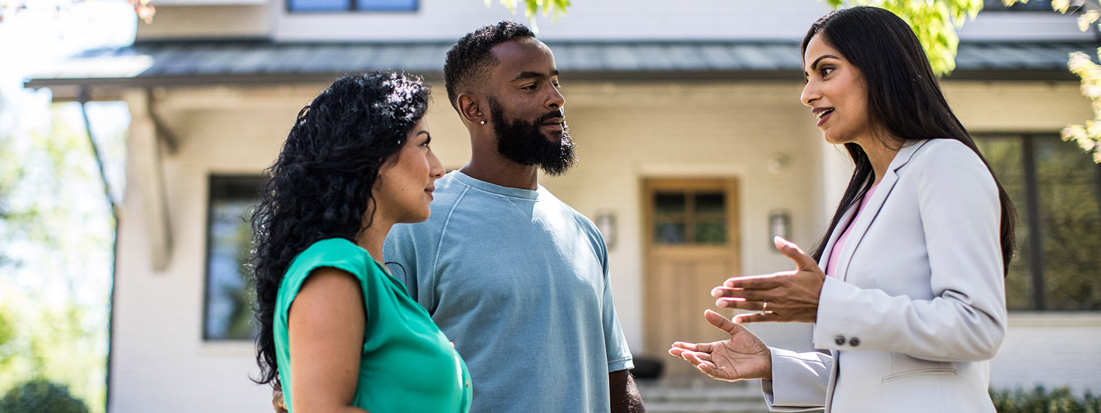 Real estate agent talking to her customers