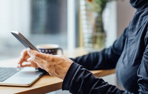 Woman sitting in front of a laptop, thinking about low down payment mortgage options