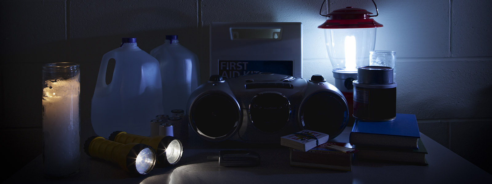 Emergency supplies including water bottles and flashlights sitting on a counter for winter weather emergency hacks