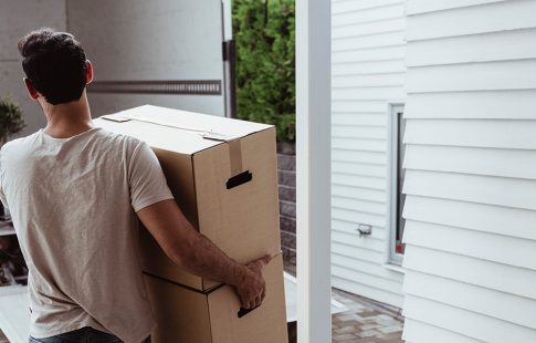 Man carrying boxes to a moving truck