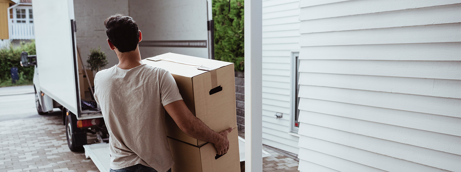 Man carrying boxes to a moving truck