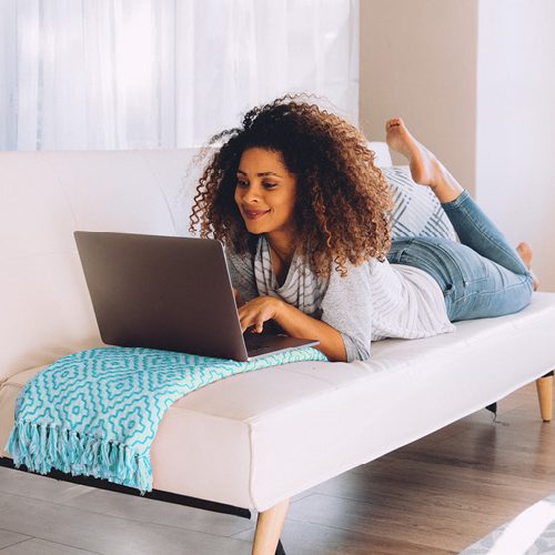 Woman Laying Down on Computer