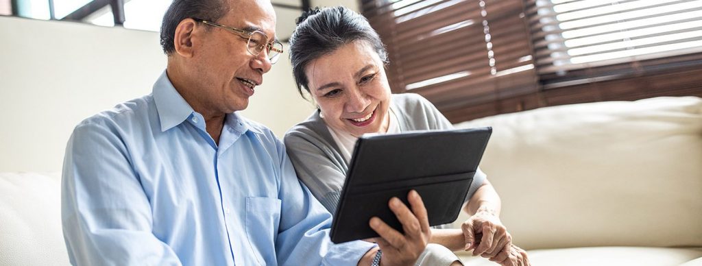 Couple considering a cash out refinance looking at tablet cash out refinance 