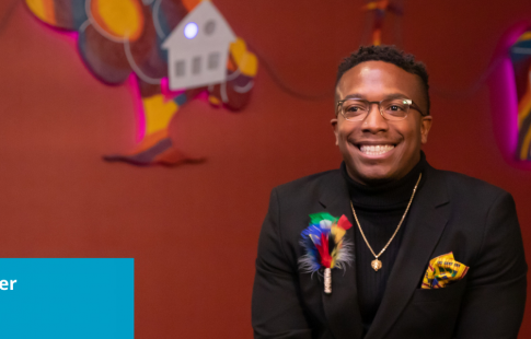 Photo of Demarcus Brewer smiling while talking about Black History Month. The image has a Great Place To Work Certified logo on it and a blue box with text: Demarcus Brewer, AVP FLOD