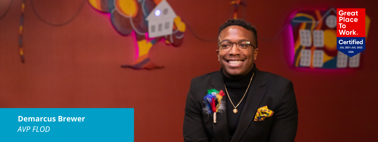 Photo of Demarcus Brewer smiling while talking about Black History Month. The image has a Great Place To Work Certified logo on it and a blue box with text: Demarcus Brewer, AVP FLOD