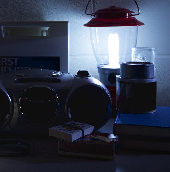 Emergency supplies including water bottles and flashlights sitting on a counter for winter weather emergency hacks