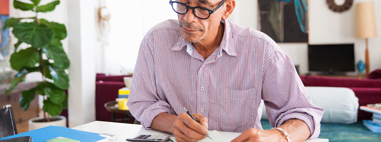 Man looking at a calculator as he considers, "When is a cash out refinance a good idea?"
