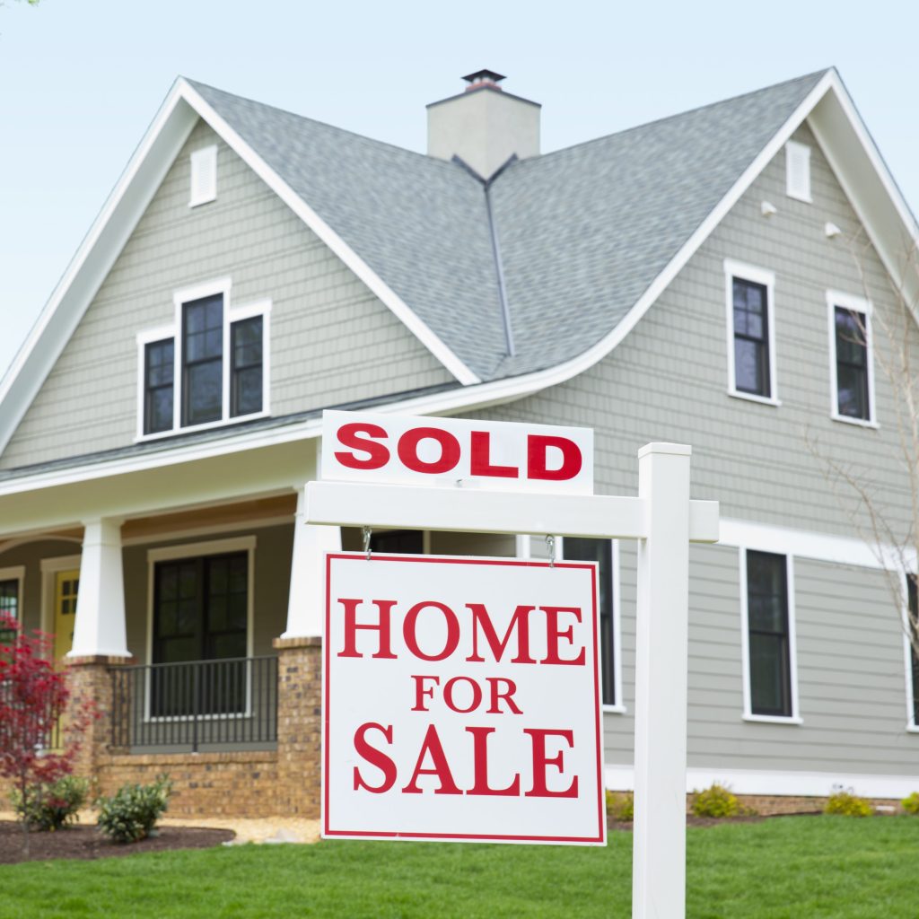 Two-story craftsman home with a sold sign in the yard. Read on for tips on how to win a bidding war.