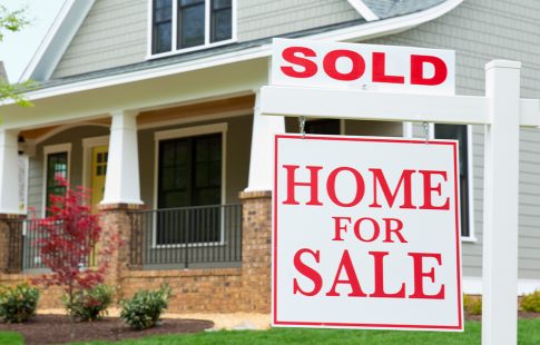House with a sold sign in the yard. Read on for tips on how to win a bidding war on a house.