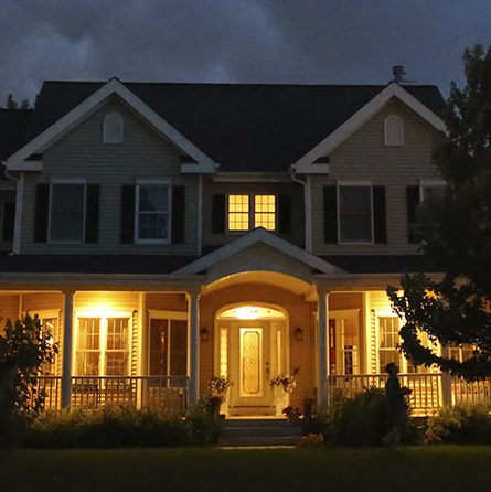 Lightning strikes behind a home