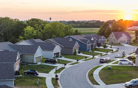 Neighborhood of homes with sun rising in the background