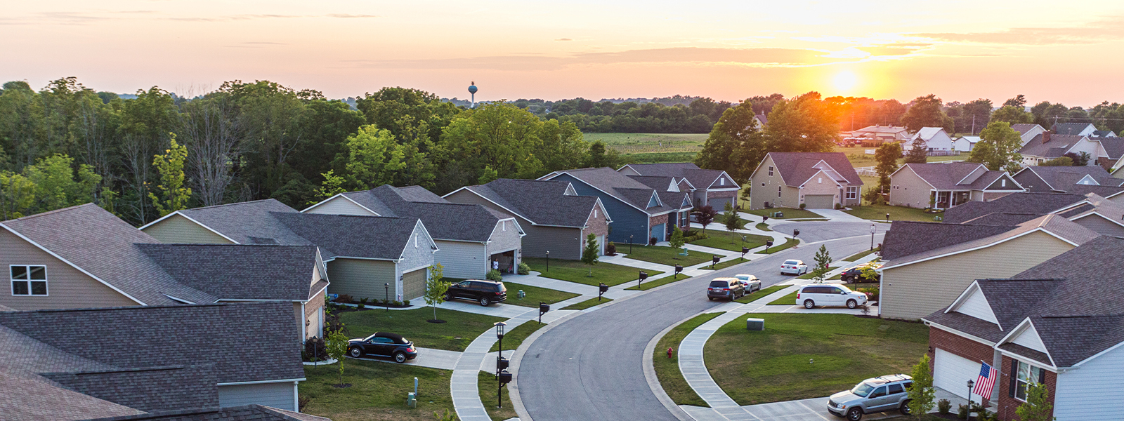 Neighborhood of homes with sun rising in the background