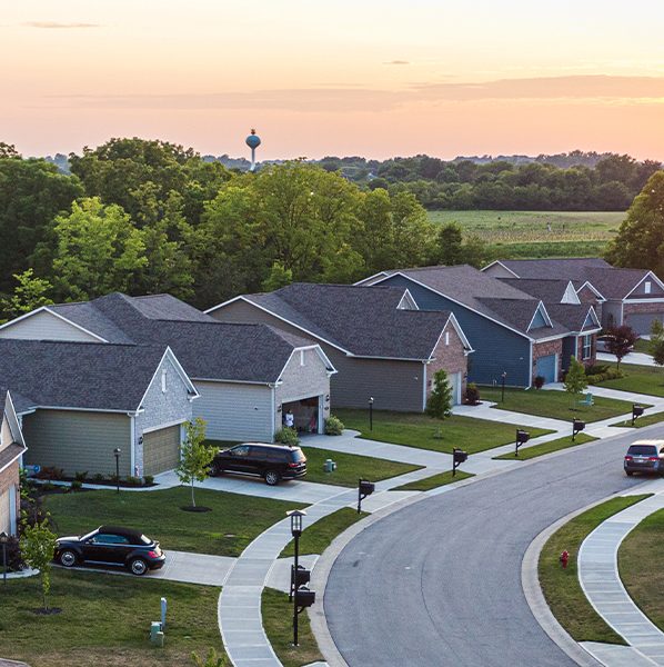 Neighborhood of homes with sun rising in the background