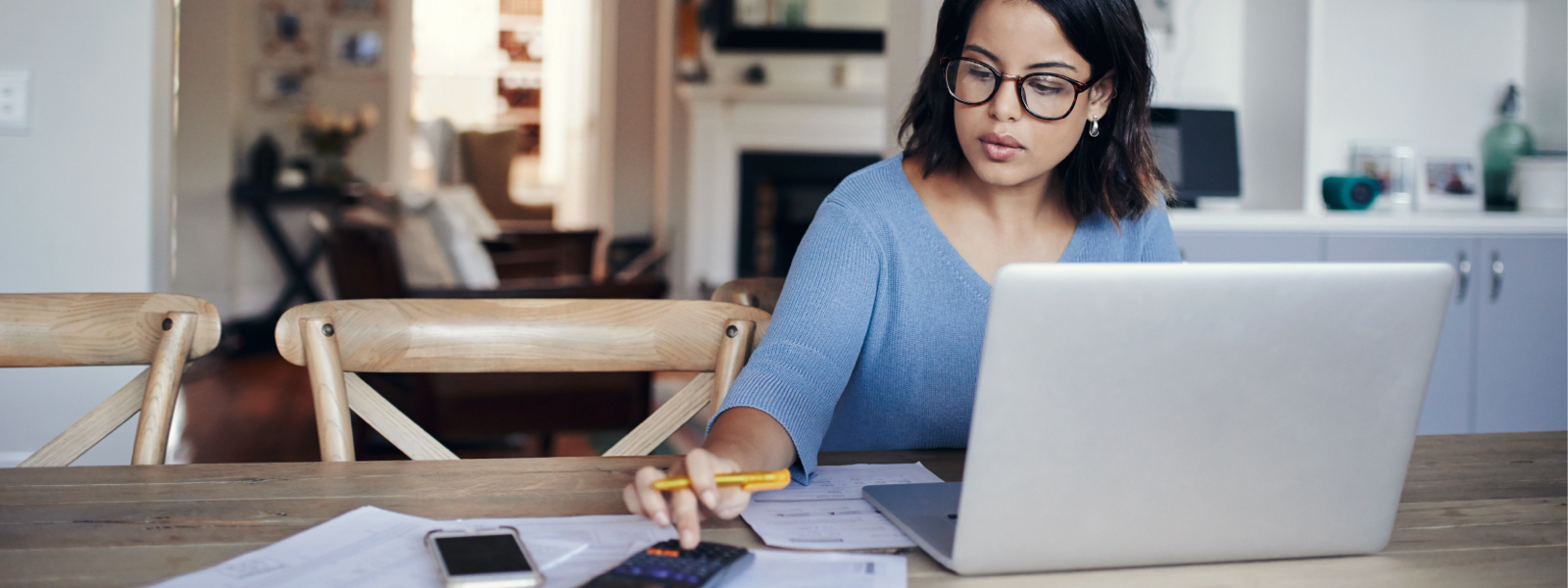 Woman working on a calculator after wondering, "what is escrow and how does it work?"