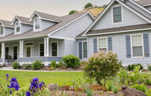 Blue house with a landscaped yard