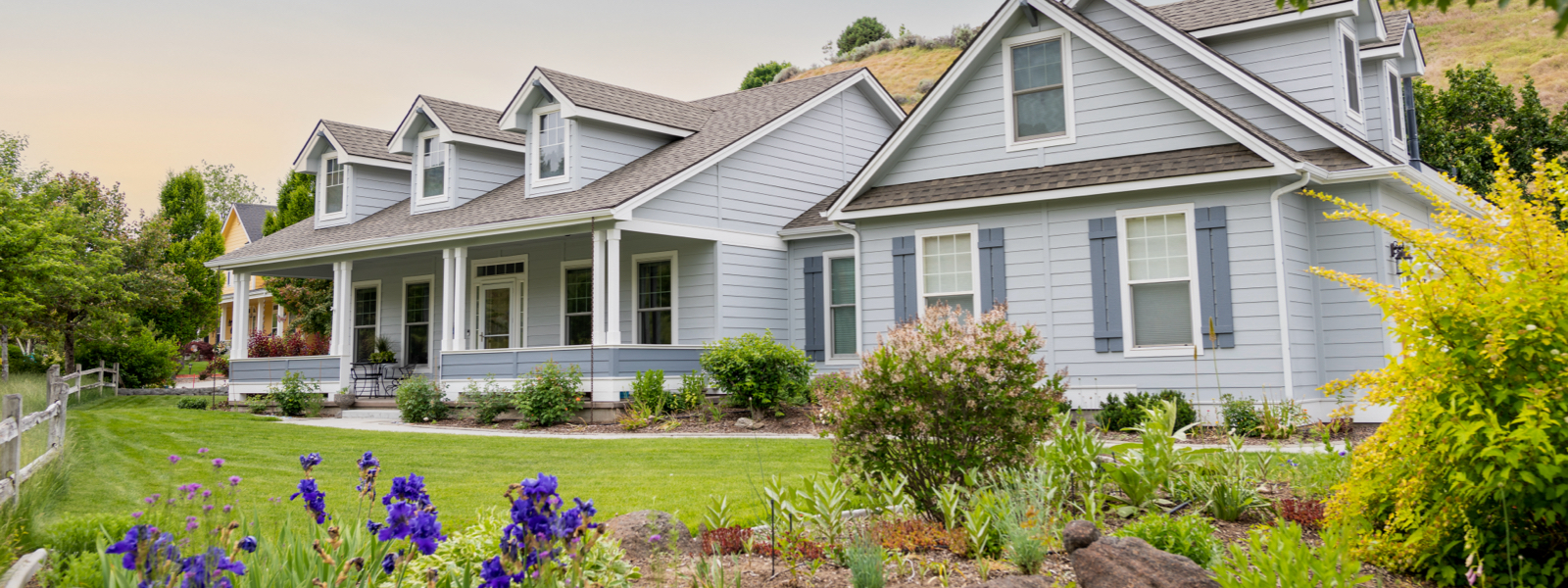 Blue house with a landscaped yard
